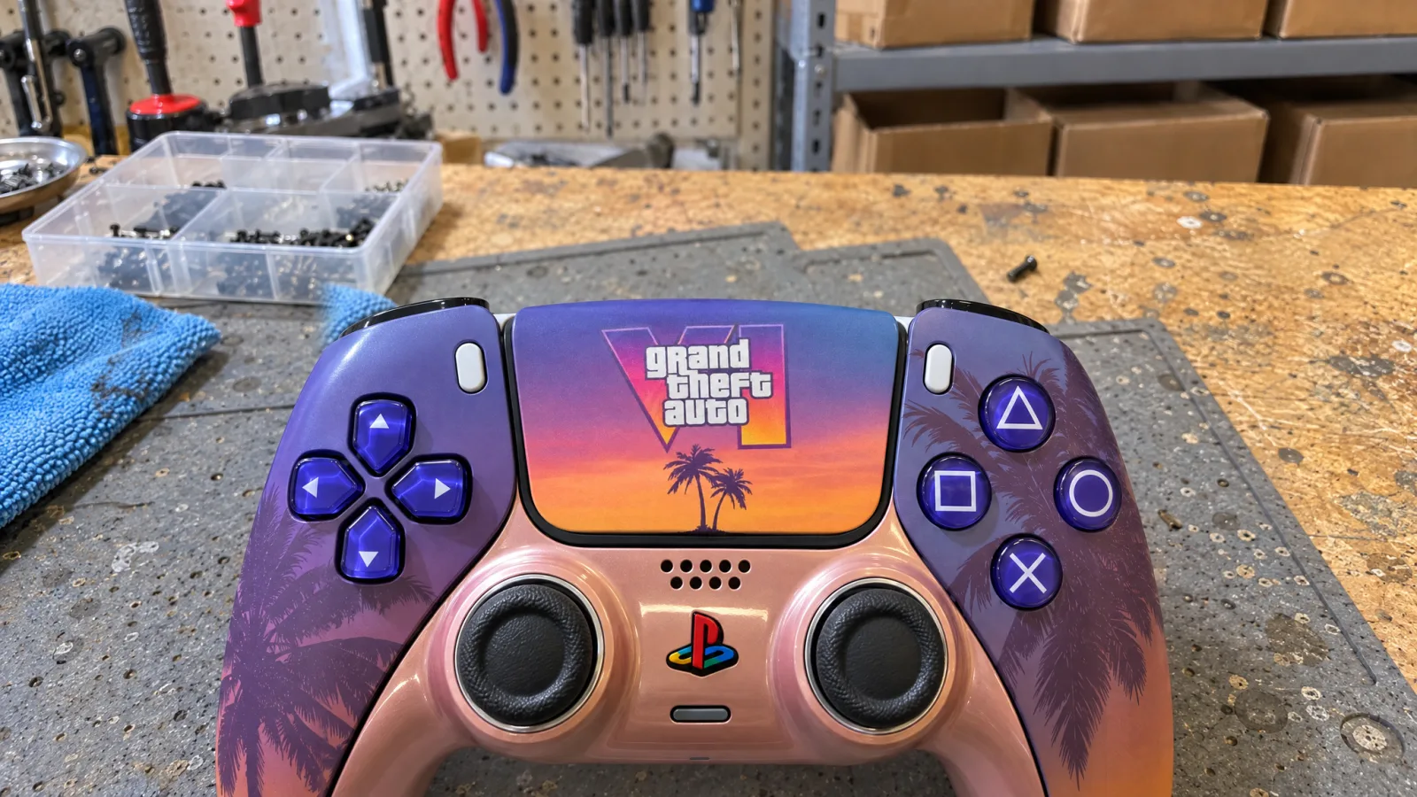 Close-up of the touchpad with the GTA VI logo and palm trees